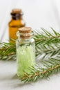 Spa with organic spruce oil and sea salt in glass bottles on white table background Royalty Free Stock Photo