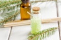 Spa with organic spruce oil and sea salt in glass bottles on white table background Royalty Free Stock Photo