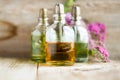 Spa perfume essential aroma oil glass bottles with flower blossoms on old wooden background Royalty Free Stock Photo