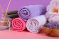 Spa on a pink pastel background. Towels, stones, aromamaslo, purple salt bath and pink flowers. Royalty Free Stock Photo