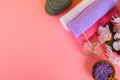 Spa on a pink pastel background. Towels, stones, aromamaslo, purple salt bath and pink flowers. Royalty Free Stock Photo