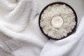 Top view of sea salt, candle, white towels.Concept of spa treatments Royalty Free Stock Photo