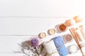 Spa products. Bath salts, dry flowers lavender, soap, candles and towel. Flat lay on white wooden background, top view Royalty Free Stock Photo