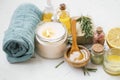 Spa products with candle, towels, manuka honey, oils, clay, bath salt, salve balm, spa setting with natural products for skincare Royalty Free Stock Photo