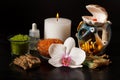 Spa products and white orchid flower on black background Royalty Free Stock Photo