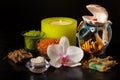 Spa products and white orchid flower and candles on black background Royalty Free Stock Photo