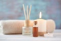 Towels, candle and massage oil on white table Royalty Free Stock Photo