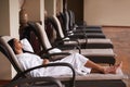Spa, relax and woman in chair for beauty, skincare and wellness treatment in luxury hotel. Resort, hospitality and Royalty Free Stock Photo