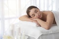 Spa Relaxation. Young Indian Woman Lying On Massage Table In Beauty Salon Royalty Free Stock Photo