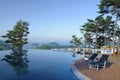 Spa resort hotel infinity swimming pool, mountains and islands in distance