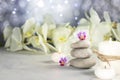 Spa resort therapy composition. Stones, burning candles, towel, abstract lights