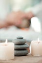 Spa, rock and candle to relax in a room with atmosphere, mood or ambience in a health club. Wellness, luxury and