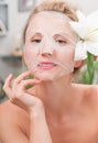 Spa salon. Beautiful woman with facial mask at beauty salon Royalty Free Stock Photo