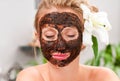 Spa salon. Beautiful woman with facial mask at beauty salon Royalty Free Stock Photo