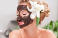 Spa salon. Beautiful woman with facial mask at beauty salon Royalty Free Stock Photo