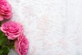 Spa salt crystals and pink Roses with green leaves on white shabby table. Flat lay