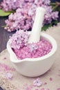 Spa sea salt in mortar and lilac flowers. Royalty Free Stock Photo