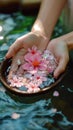 Spa serenity Female hand and flower in a serene water setting