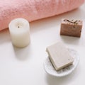 Spa set. Bar of handmade soap, candle and towel. Accessories for personal hygiene. Decor for bathroom interior Royalty Free Stock Photo