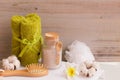 Spa set with bath solt, comb and towel on white wooden background Royalty Free Stock Photo