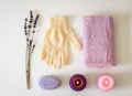 SPA set with lavender soap, exfoliating massage peeling glove, pink towel and purple candles. Royalty Free Stock Photo