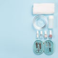 Spa set, manicure or pedicure equipment with nail coat or polish, on blue background, top view, copy space, square format Royalty Free Stock Photo