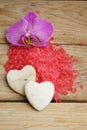 Spa set with red sea salt, bright orchid flower and stones in the form of hearts. Royalty Free Stock Photo