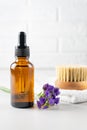 Spa set for skin care. Bottle of aromatic lavender essential oil and wooden brush with natural bristle for dry massage. Healthy Royalty Free Stock Photo