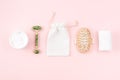 Spa set, towels, massaging brush, body cream, marble roller on pink surface. Eco zero waste concept. Royalty Free Stock Photo