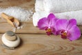 Spa set with white towels, sea salt and bright orchid flowers Royalty Free Stock Photo