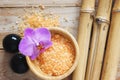 Spa set on wooden table, bath salt, flower of orchid, natural bamboo, Bian stones. Royalty Free Stock Photo