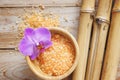 Spa set on wooden table, bath salt, flower of orchid, natural bamboo. Royalty Free Stock Photo