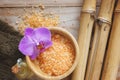 Spa set on wooden table, bath salt, flower of orchids , natural bamboo and massage oil. Royalty Free Stock Photo