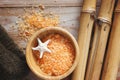 Spa set on wooden table, bath salt, sea star and soft towel. Royalty Free Stock Photo