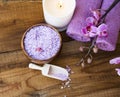 Spa setting with bath salt, orchid , candle, towels and on wooden board top view Royalty Free Stock Photo