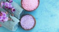 Spa setting with bath salt, orchid and towels top view on painted wood board Royalty Free Stock Photo