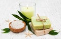 Spa setting with candle, handmade soap and salt