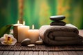 Spa setting with candles, towel and orchid flowers on bamboo mat, Spa concept with eucalyptus oil and eucalyptus leaf extract Royalty Free Stock Photo