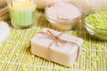 Spa setting with natural soap, bath salts and candle. Royalty Free Stock Photo