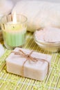 Spa setting with natural soap, bath salts and candle. Royalty Free Stock Photo