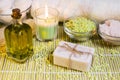 Spa setting with natural soap, olive oil, bath salts and candle. Royalty Free Stock Photo