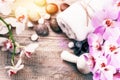 Spa setting with pink orchid, herbal massage ball and essential Royalty Free Stock Photo