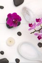 Spa setting with pink orchids, black stones on white wood background. Royalty Free Stock Photo