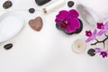 Spa setting with pink orchids, black stones and bath salts on wood background. Royalty Free Stock Photo