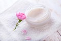 Spa setting with pot of moisturizing cream beautiful pink roses and rose oil on white background top view Royalty Free Stock Photo