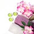 Spa setting of towel, flower, coffee on white. Copy space. Relax. Royalty Free Stock Photo