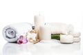 A spa setting with white towels, candles, and orchids Royalty Free Stock Photo