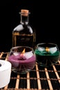 Spa still life with aromatic candles on black background Royalty Free Stock Photo