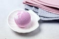 SPA Still Life Background Pink Bath Bomb on White Plate in Shape of Shell Pink and Gray Towels Spa Beauty Concept Royalty Free Stock Photo