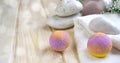 Spa still life composition. Bath balls, stones, body scrub jar, towel on wooden background.